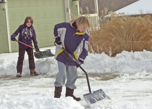 Brendan Clouston and Logan Clancy took advantage of the holiday school break and last week's snow to earn extra money by shoveling driveways in the Timber Lakes subdivision. If forecasts hold, De Soto and the region will get a respite from the near monthlong grip of winter weather that produced a white Christmas.