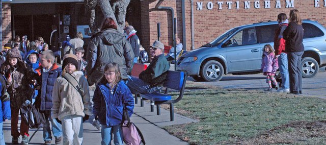 Parents wait as students file out of Nottingham Elementary School Tuesday afternoon. Though the new elementary school will not be open until fall 2009, the Eudora USD 491 School Board has begun to look into options it has with the Nottingham property, as well as others such as the Community Learning Center and Laws Field.