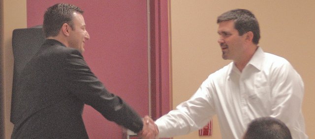 Eudora USD 491 Superintendent Marty Kobza accepts congratulations from 2007 Eudora Chamber of Commerce President John Flore on the school district being named the chamber's business of the year at the organization's annual dinner Saturday at the community center.
Local pharmacists Stan Byrne was named chamber member of the year.