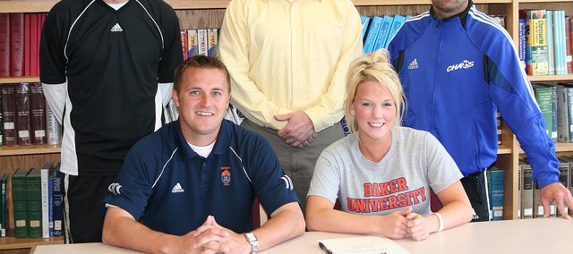 Alyssa Kelly, the leading scorer on the Bonner Springs girls soccer team, will play soccer in college next year at Baker University. Pictured at the signing ceremony are, from left, seated: BU assistant coach Blake Reynolds and Alyssa Kelly; and, standing: BSHS coach Mike Mullin, Tim Kelly and BSHS assistant coach Shannon Frank.