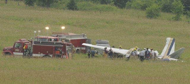 Federal Aviation Administration personal and Kansas Highway Patrol Troopers work the scene of a plane crash about 6 p.m. Tuesday, June 24 near the intersection of Leavenworth County Road 1 and Cantrell Road south of Tonganoxie. Two people were killed in the crash, which occurred about 10:30 a.m. Tuesday.