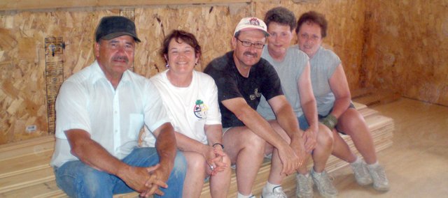 Building owner Jerry Lytle (left) and Basehor United Methodist Church missionaries Margee Castle, Jim Bebb, Ferna Mosher and Janice Kocher sit beneath a tongue and groove ceiling they helped install at a soon-to-be Children's Cultural Center on the Crow Creek Indian Reservation in Fort Thompson, S.D. The group travels to the area for a mission trip annually.