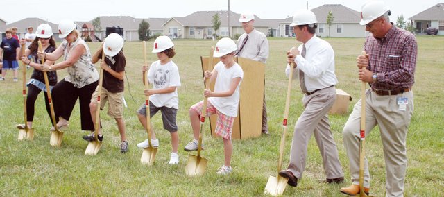 Eudora Superintendent Don Grosdidier looks on as Eudora Middle School seventh-grader Hannah Penrose, Eudora Board of Education member Belinda Rehmer, EMs
eighth-grader Matthew Damm, EMS sixth-grader Joel Dixon, West Elementary fifth-grader Liz Kendall, EMS Principal Richard Proffitt and Eudora Board of Education President Kenny Massey participate Friday in the groundbreaking ceremony for the expansion of Eudora Middle School. The expansion is set to be finished in fall 2009 and will feature a new commons area and sixth-grade classrooms.