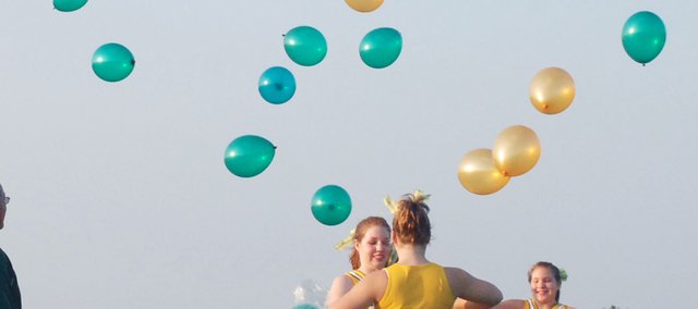 Basehor-Linwood High School cheerleaders release balloons into the sky as members of the school board look on during the dedication ceremony for the new soccer facility at BLHS on Monday evening. The celebration was short-lived, however, as the Bobcats dropped a 3-2 decision in double-overtime to visiting Sumner Academy.