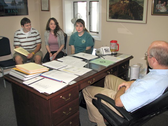 Kansas City Kansas Community College students Michael Kelling (left), Piper, Mary Katherine Swabb (middle), Basehor, and Cheyenne Pike, Kansas City, Kan., talk with Basehor City Administrator Carl Slaugh about a curbside recycling survey. The students plan to conduct a survey this month in Basehor as a part of their Greening Society Learning Community class.