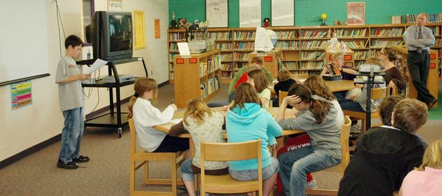 Jackson Barth, left, a fifth grader at Baldwin Elementary School Intermediate Center, gives a report about President Abraham Lincoln on Tuesday. The fifth graders have been studying Lincoln this year as a part of his 200th birthday and will travel to his birthplace, Springfield, Ill., Friday. Listening at right is Principal Tom Mundinger, who spearheaded the field trip effort.