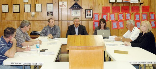 It was changing of the guard time for the Baldwin City Council meeting Monday night where Ken Wagner, center, took over as mayor. Also joining the council were Tom Farmer, second from left, and Bonnie Plumberg, right. They took seats at the council table with Council Member Mike Magers, left, City Administrator Jeff Dingman, City Clerk Darcy Higgins and Council Member Ted Brecheisen, Jr.