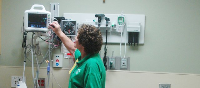 Registered nurse Mary Chance works with equipment in one of the new rapid medical rooms of the newly expanded Emergency Services area. Providence Medical Center Saint John Hospital had an open house Saturday to reveal renovations it made to the center. The project for renovation began in 2007, and Saturday was the first public viewing. About 500 attended the event.