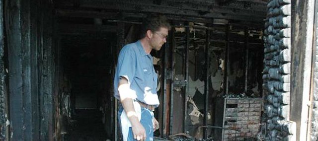 Bonner resident Mike Charlson stands amid the wreckage left by an electrical fire in his home. The fire occured Saturday morning, July 4. 