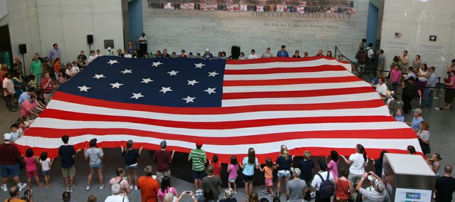 Students, parents and teachers from Monticello Trails and Mill Creek middle schools and Mill Valley High School unfurled a 50-foot flag in front of the original Star-Spangled Banner in the Smithsonian’s National Museum of American History. The replica flag was the brainchild of Carly Granato and Jill Applegate, students in Keil Hileman’s Museum Connections class. The group was in Washington over Labor Day weekend as part of an annual tour led by Hileman, a Monticello Trails history teacher.