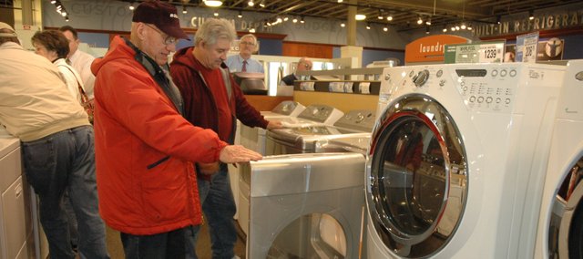 Don Bearley (left) and Richard Sheumaker look at some Energy-Star-rated appliances at Nebraska Furniture Mart, in Kansas City, Kan. Some Kansas residents participating in the State Energy Efficient Appliance Replacement Program will have the opportunity to receive rebates on the purchase of new Energy Star-rated appliances such as these.