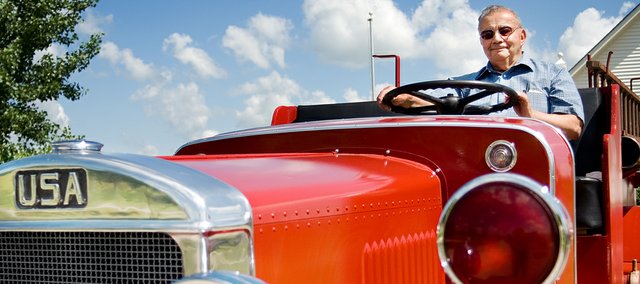 Allen DiSanto sits on top of a 1936 fire truck that was once used in the city of Tonganoxie. He and other volunteers from the Tonganoxie Community Historical Society and additional community members have spent the last three years restoring the truck to working condition. See page 5 for the complete story about the restoration.