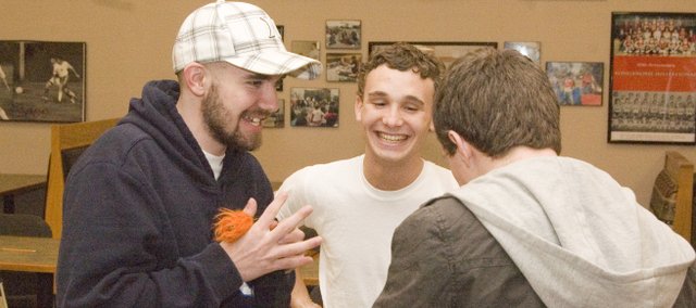 Austin Stone, left, jokes around with former Tonganoxie High School 4x400 relay team members Bret Koch, middle, and Jeremy Carlisle, right, during a reception for another 4x400 team member, DJ Lindsay, who was signing to run track at Wichita State University. Stone keeps in touch with former classmates at Tonganoxie High School.