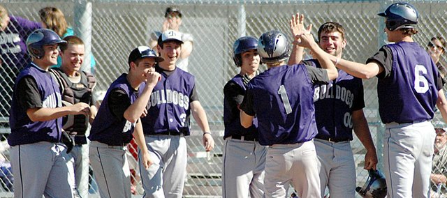 Baldwin High School sophomore Hunter Burkhart (No. 1) is greeted by teammates at home plate after his first inning home run Tuesday. Burkhart hit another homer two innings later.