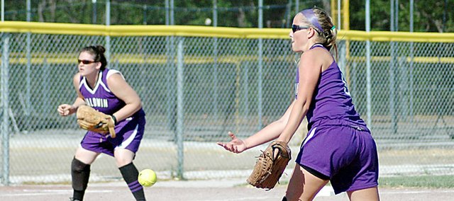 Baldwin High School sophomore Hayley Schwartz pitches Tuesday while junior Karlee Beach covers third base. The Bulldogs were swept by Eudora.