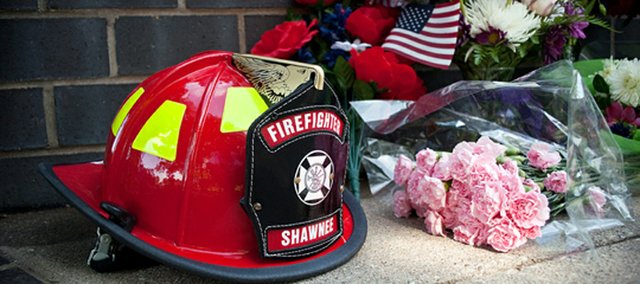 As part of the memorial, Shawnee Fire Department Captain Ray Pettigrew put a helmet with John Glaser's last name in front of the fallen officer firefighter memorial at station 71. 