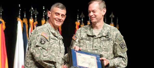 Lt. Gen. Robert Caslen Jr., commanding general of the U.S. Army Combined Arms Center and Fort Leavenworth, left, hands Brig. Gen. Sean MacFarland his assumption orders during the change of responsibility ceremony at Fort Leavenworth Friday. MacFarland officially took the post of deputy commandant of the U.S. Army Command and General Staff College and deputy commanding general of the U.S. Army Combined Arms Center-Leader Development and Education replacing the previous deputy commander Maj. Gen. Edward Cardon.