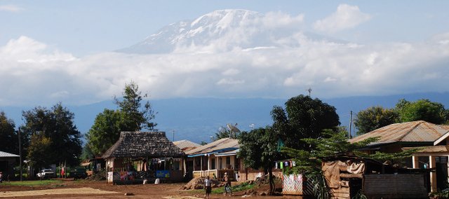 Mount Kilimanjaro towers over a nearby village in Tanzania. Kilimanjaro stands 19,341 feet high and is the highest free-standing mountain in the world.
