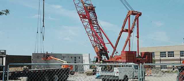 The massive crane being used to place the pre-cast concrete walls for the safe room at the new Performing Arts Center started the process Tuesday morning. The PAC is being built between Baldwin High School and Baldwin Junior High School. It is unknown when the project will be completed. The Signal will have a story on the project in this week's Signal, which will be available Thursday.