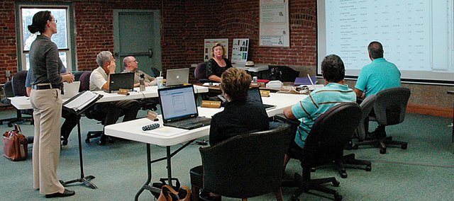 Director of Financial Operations Cynde Frick, left, reviews the Baldwin School District budget with the school board Monday night. The school board unanimously approved the 2010-2011 budget, which included a 3-mill decrease from the Capital Outlay budget. The overall mill levy will still increase by 4.497 mills this year.