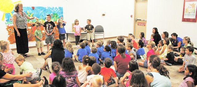 Storyteller Jo Ho leads children through a discussion about reptiles in a Story Hour performance last month at the Johnson County Museum. Officials at the Johnson County Museum and Wonderscope Children’s Museum say they need more space for their exhibits and additional programs such as these.