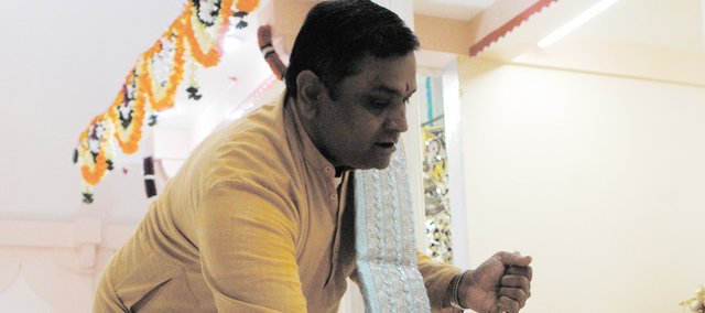 Atul Trivedi of Shawnee, a Hindu priest, worships at the Hindu Temple and Cultural Center of Kansas City, 6330 Lackman Road in Shawnee. The temple, which draws worshipers from the entire metropolitan area and surrounding communities, is planning a Diwali – or Festival of Lights – celebration Nov. 6, which will include fireworks at Swarner Park. 