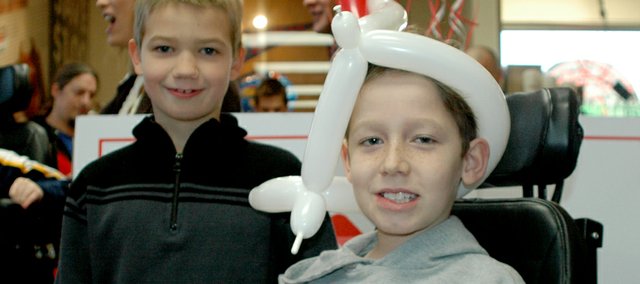Benninghoven third graders Sam Rice, right, and Ryder Jarrett attend Young Variety Kansas City's "Reverse Happy Hour" Feb. 9 at Krispy Kreme. Last year, Young Variety helped pay for additions to Sam's wheelchair that his insurance wouldn't provide.