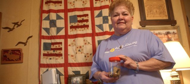 Eleanor Large of Linwood holds a jar of stones she uses to keep track of the number of laps she’s completed while participating in the K-State Extension Walk Kansas program. Large lost 30 pounds the first year she participated in the event. In the past, the program had six team members sharing in walking the equivalent of the 423 miles needed to cross the state east to west in an eight-week period. This year’s event, which will kickoff locally with a rally at 9:30 a.m., Saturday, March 12 in Leavenworth, will allow teams to opt for the more challenging equivalent of walking around Kansas or 1,200 miles.
