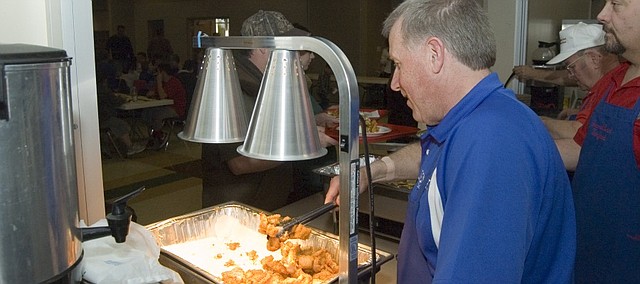 Knights of Columbus members serve fish during a recent fish fry at Sacred Heart Catholic Church.
The church serves fish on Fridays during the Lenten season each year. Today, Friday, April 15, is the final day this year the church will be serving fish. Shrimp also will be served at the final fish fry.