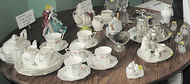 Sue Lynch (left) and Opal Trefethen, both of Eudora, inspect some English tea sets on sale at Madame Hatter’s Tea Room, 228 Oak St. Madame Hatter’s announced last month that it was closing. This week, from 11 a.m. to 3 p.m. daily as long as its inventory lasts, the restaurant is selling its tea pots and other items. See story page 9.