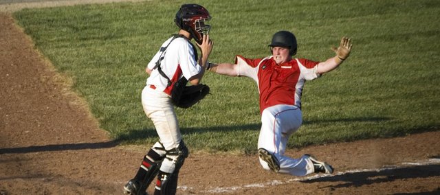 Tonganoxie's Tucker Hollingsworth slides home to give Post 41 a two-run lead in the fourth inning Monday night at Eisenhower Park in Kansas City, Kan. Post 41 lost for the first time this season, 9-8, to the Kansas City Cyclones in the first round of the Class AA Zone 2 double-elimination tournament.