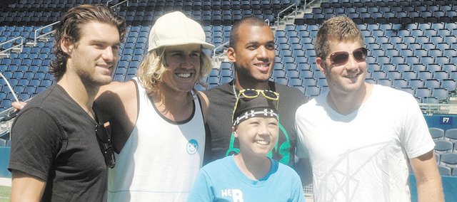 Hope Corwin (middle), Kansas City, Mo., is surrounded by members of the Sporting Kansas City soccer team during the 2011 Cattle Baron’s Ball Children’s Party at LIVESTRONG Sporting Park. The event Tuesday gave youths battling cancer a chance to take part in a soccer clinic and tour the stadium. Pictured from left are Graham Zusi, midfielder; Chance Myers, defender; Teal Bunbury, striker; and Luke Sassano, midfielder.