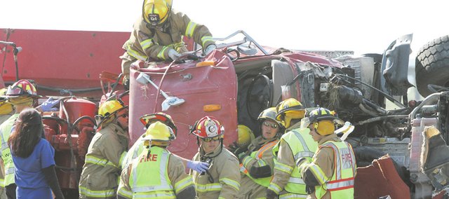 Douglas County Sheriff's deputies worked with Kansas Highway Patrol troopers and emergency personnel from Eudora and Lawrence to free a truck driver for Penny's Concrete from his rig about 4:30 p.m. on Thursday Aug. 25, 2011 near the Eudora exit on Kansas Highway 10 after it overturned, pinning him inside. The driver was flown by helicopter ambulance to an area hospital.