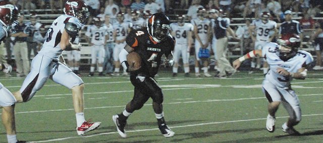 Bonner Springs senior quarterback Jourdaine Smallwood found room to run up the middle during the fourth quarter against Topeka Seaman. The Braves won 21-17.