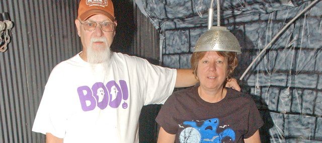 Rick and Kathy Bowen are preparing for their Halloween Bowen Bash at their homestead east of Tonganoxie that will both spook and indulge their guests. The couple annually invite about 80 relatives and friends for an evening of chills, including a haunted barn that this year will include the electric chair Kathy is strapped into, and tables filled with food.
As part of the event, the couple decorates their homestead with a variety of Halloween items, such as the gargoyle at bottom.