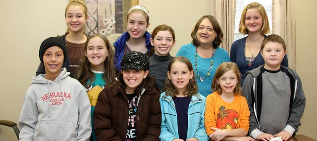 Members of the Great Plains 4-H Club quilting and art theory projects are pictured with Diane Bryant, activities director at Sharon Lane Health Services. The 4-Hers made quilted stockings stuffed with useful items for Sharon Lane residents.