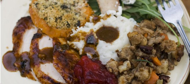 The turkey may be the centerpiece, but a classic Thanksgiving dinner simply isn’t complete without a bevy of traditional sides. Pictured is a dinner plate of cider brined turkey with sage gravy, peach cranberry sauce, sour cream and chive mashed potatoes, sausage pecan stuffing, arugula pear salad with pomegranate vinaigrette and goat cheese and herb crusted sweet potatoes.