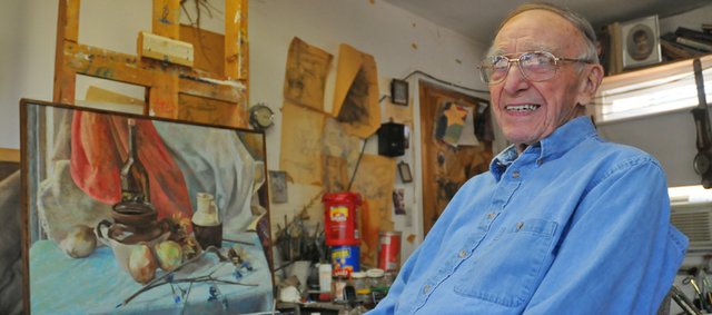 Tom Russell sits in front of an easel in a studio in his Baldwin City home. The 95-year-old former head of the Baker University art department, works in the studio daily. Russell will be honored Sunday at the annual chocolate. He and his late wife, Alice Anne, brought the auction, which now benefits the Lumberyard Arts Center, to Baldwin City 25 years ago after witnessing a similar event in South Dakota.