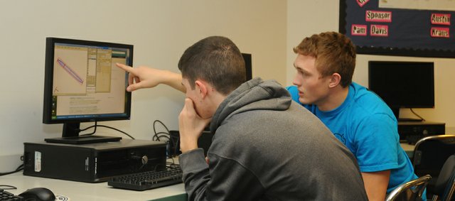Senior Colton Horne explains a detail of an engineering design program to freshman Jackson Barth during Sunday's work session of Baldwin High School's Real World Design Challenge team. The team recently learned it won the state competition and will travel in April to Washington, D.C., to defend the national championship the school's team won last year.
