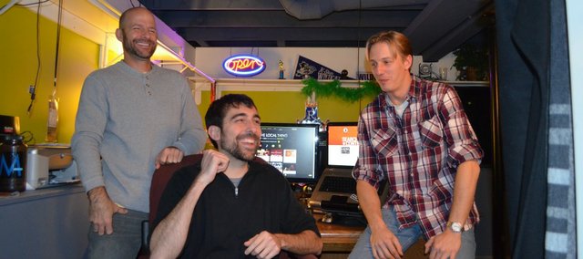 Matthew Marcus, left, and Adam Arrendondo, center, of Local Ruckus LLC get pumped up during a recent conversation about Google Fiber with Tyler Van Winkle of Leap2 LLC. Both startup companies are located in a house at 4454 State Line, which is in Kansas City, Kan.’s Hanover Heights fiberhood — the first to receive the 1-gigabit Internet service.
