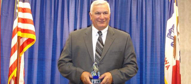 Baldwin High School girls track coach Ted Zuzzio holds the trophy he received when he was inducted into the National High School Athletic Coaches Association Hall of Fame for his accomplishments as girls basketball and track coach during his 37-year career at BHS.
Zuzzio was presented the honor at a gathering Wednesday in De Moines, Iowa.
