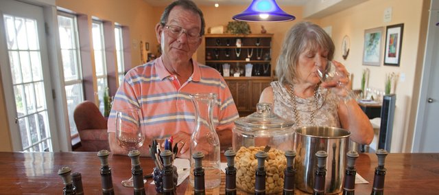 Mark and Pam Thomeczek of Marshall, Mo., sample wine in the tasting room at BlueJacket Crossing Vineyard and Winery outside Eudora. BlueJacket Crossing, a designated Kansas agritourism site, sells more wine by being able to offer a farm experience to go with it, owner Pep Selvan-Solberg says.
