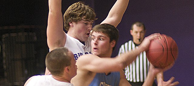 Baldwin seniors Luke Fursman, 21, and Quinn Twombly put pressure a Chanute player into a turnover in the first half of Monday's BHS victory in the Bulldog/Wildcat Classic. The Bulldogs will play Iola at 7 p.m. Wednesday at the Baldwin Junior High School Gymnasium to complete the tournament's pool play.