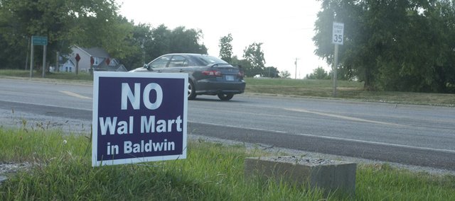 The signs in opposition to the proposed Wal-Mart Express have mostly disappeared with Wal-Mart Inc.'s decision not to go forward with a plan to build the store at a proposed U.S. Highway 56 site. Opponents are nonetheless being proactive in case the retail giant proposes a different location and with measures that would protect against other such plans.