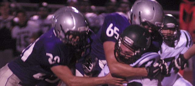 All-Frontier League offensive an defensive first-team selection Christian Gaylord, 65, makes a tackle in a Baldwin HIgh School game this fall. He and junior Joel Katzer made first-team honors on both sides of the ball.