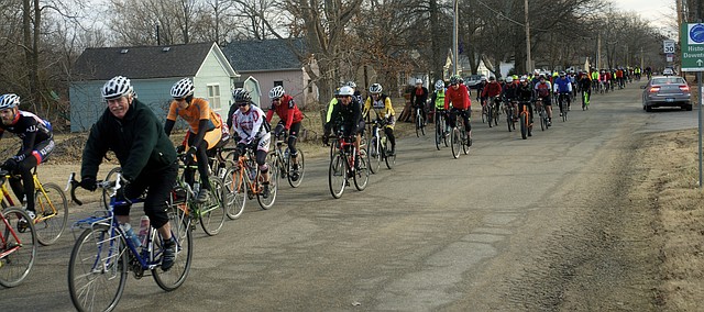 About 120 bicyclist head west Saturday on High Street at the start of the annual Mullet Ride. The riders would complete one or two laps of a 28-course of gravel roads near Baldwin City.