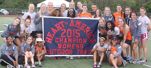 Members of the Baker University women's track team pose Saturday with the championship banner after winning the school's fourth-straight conference team title. The men's team won the school's fifth-straight title.