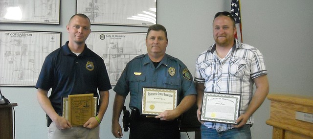 From left, Basehor Police officers Joel Glavin and Lt. Robert Pierce, along with Austin Fisher, Basehor Public Works Department employee, were recognized for their work in apprehending a sex offender last year at Monday's Basehor City Council meeting. Officer Bob VanCleave, who was not able to attend the meeting, also was recognized.