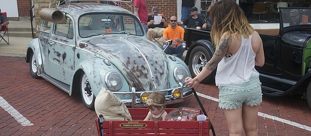 A young mother stops to look at a vintage VW bug at the Baldwin City Chamber of Commerce car show in June. The show was one of many events that drew visitors to the community, and was one of many events that kept the chamber busy after it added Hank Booth its first-ever executive director. Later in the year, Jennette Blackmar state as office manager at its new office location in the Lumberyard Arts Center.