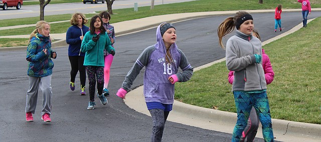 Girls on the Clear Creek Elementary Girls on the Run team run laps during Thursday's practice. The team, establish five years ago, currently has about 25 members.